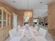 Bright dining room with a decorative chandelier and table, adjoining a seating area at 1611 Thomas St, Englewood, FL 34223