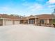 Inviting exterior featuring a large driveway, well-maintained landscaping, and a charming facade at 1611 Thomas St, Englewood, FL 34223