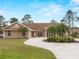 Charming home featuring a beautiful driveway, well-manicured lawn, and lush landscaping at 1611 Thomas St, Englewood, FL 34223