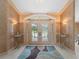 Grand foyer with decorative lighting, beautiful doors, and elegant decor at 1611 Thomas St, Englewood, FL 34223