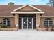 Charming front entrance with decorative dolphin screen doors and manicured landscaping at 1611 Thomas St, Englewood, FL 34223