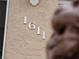 Close-up of the house number '1611' affixed to the textured exterior wall at 1611 Thomas St, Englewood, FL 34223