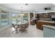Eat-in kitchen with backyard pool view, modern light fixture, and stainless appliances at 1611 Thomas St, Englewood, FL 34223