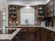 Kitchen featuring wood cabinets, granite countertops, tile backsplash, and stainless steel sink at 1611 Thomas St, Englewood, FL 34223