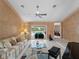 Open living room with a view of the pool through sliding glass doors and cozy furnishings at 1611 Thomas St, Englewood, FL 34223