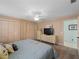 Spacious bedroom featuring neutral walls, carpet, and a large bed with decorative pillows and access to closets at 1611 Thomas St, Englewood, FL 34223
