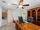 Office space with built-in bookshelves, a large wooden desk, carpet flooring and views to the rest of the home at 1611 Thomas St, Englewood, FL 34223