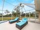 View of pool with screened-in enclosure, chaise lounges and view of backyard at 1611 Thomas St, Englewood, FL 34223