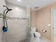 Modern tiled shower with glass enclosure, handheld shower head, and neutral walls, plus toilet at 1611 Thomas St, Englewood, FL 34223
