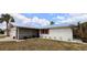Cozy single-story house with red trim, a well-maintained lawn, and a screen door at 237 Venice East Blvd, Venice, FL 34293