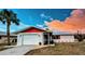 Beautiful one-story home with a vibrant lawn, attached garage, and screened-in porch at 237 Venice East Blvd, Venice, FL 34293