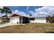Charming single-story home with a screen door entryway, white exterior, and lush landscaping at 237 Venice East Blvd, Venice, FL 34293