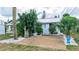 Home featuring mature landscaping, a gravel driveway, and white rock accents at 237 Venice East Blvd, Venice, FL 34293