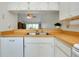 Modern kitchen featuring stainless steel sink, and butcher block counter with view into the living area at 437 Cerromar Ln # 513, Venice, FL 34293