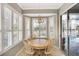 Cozy dining area featuring bay windows with plantation shutters and a stylish chandelier at 522 Fallbrook Dr, Venice, FL 34292
