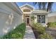 Inviting front entrance with mature landscaping and a charming walkway to the front door at 522 Fallbrook Dr, Venice, FL 34292