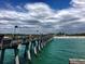 Picturesque pier extending into the ocean under a partly cloudy sky, near sandy beach at 523 Park Estates Sq, Venice, FL 34293