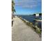Scenic waterfront view with a boat, pathway, and lush greenery at 523 Park Estates Sq, Venice, FL 34293