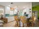 Well-lit kitchen with white cabinets, breakfast bar and blue backsplash at 5755 Ivrea Dr, Sarasota, FL 34238