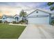 Charming single-story home with a well-maintained lawn, lovely landscaping, and a two-car garage at 5891 Madison Rd, Venice, FL 34293