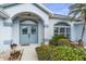 Elegant double front doors framed by an arched entrance and manicured landscaping at 5891 Madison Rd, Venice, FL 34293