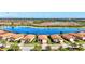 Aerial view of a single-story home and water feature in residential neighborhood at 10466 Medjool Dr, Venice, FL 34293