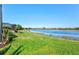 Spacious backyard featuring green grass and a serene water view, ideal for outdoor relaxation and enjoyment at 10466 Medjool Dr, Venice, FL 34293
