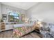 Cozy bedroom with colorful bedding, decorative accents, and a bright window view at 10466 Medjool Dr, Venice, FL 34293