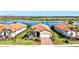 Beautiful single-story home with a lush lawn and picturesque water view at 10466 Medjool Dr, Venice, FL 34293