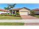 Charming single-Gathering home with a well-manicured lawn, brick driveway and 2-car garage at 10466 Medjool Dr, Venice, FL 34293