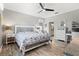 Comfortable main bedroom featuring wood-look floors, a ceiling fan, and an ensuite bathroom at 10466 Medjool Dr, Venice, FL 34293
