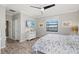 Comfortable main bedroom featuring wood-look floors, a ceiling fan, water view and a TV at 10466 Medjool Dr, Venice, FL 34293