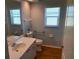 Standard bathroom with a white vanity, toilet, and window providing natural light at 1093 Laurel Woods Dr, Nokomis, FL 34275