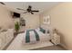 Relaxing bedroom with a ceiling fan, a decorative accent wall, and a large window at 1093 Laurel Woods Dr, Nokomis, FL 34275