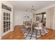 Elegant dining room with a modern table, chairs, and sliding glass doors to the outside at 1093 Laurel Woods Dr, Nokomis, FL 34275