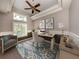 Bright home office with large window, modern desk, stylish chair, and decorative art at 1093 Laurel Woods Dr, Nokomis, FL 34275