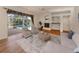 Cozy living room with a fireplace, built-in shelves, and a view of the pool at 1093 Laurel Woods Dr, Nokomis, FL 34275