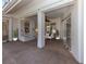 Spacious covered patio with fan, neutral decor, and sliding glass doors offering seamless indoor-outdoor living at 1093 Laurel Woods Dr, Nokomis, FL 34275