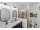 Bright bathroom features a double sink vanity, modern fixtures, and a glass-enclosed shower at 11915 Tempest Harbor Loop, Venice, FL 34292