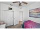 Bright bedroom with a ceiling fan, double closet, and colorful bedding at 11915 Tempest Harbor Loop, Venice, FL 34292