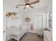 Charming Bedroom with floral accents, white crib, and a decorative mobile at 11915 Tempest Harbor Loop, Venice, FL 34292
