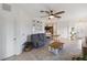 Open-concept living room with view to dining area and kitchen at 11915 Tempest Harbor Loop, Venice, FL 34292