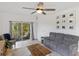Comfortable living room with a view of the screened patio and lush backyard at 11915 Tempest Harbor Loop, Venice, FL 34292
