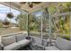 Relaxing screened patio with comfortable seating and view of the lush landscaping at 11915 Tempest Harbor Loop, Venice, FL 34292