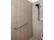 Close-up view of accessible tiled shower with safety bar at 11915 Tempest Harbor Loop, Venice, FL 34292