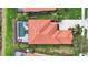 Aerial view of a house with a red tile roof, screened-in pool, and well-maintained landscaping at 133 Treviso Ct, North Venice, FL 34275