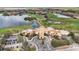 Stunning aerial view of the Venetian Golf and River Club showcasing the golf course, lakes, and community buildings at 133 Treviso Ct, North Venice, FL 34275