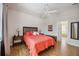 Bright bedroom with wood floors, ceiling fan, walk in closet, and ensuite bathroom at 133 Treviso Ct, North Venice, FL 34275