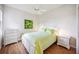 Cozy bedroom with wood floors, a queen bed, a ceiling fan, and a bright window at 133 Treviso Ct, North Venice, FL 34275