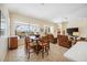 Open-concept space with a dining area flowing into the living room and offering views of the pool at 133 Treviso Ct, North Venice, FL 34275